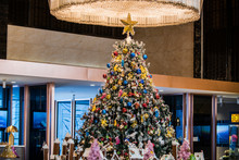 Christmas Tree Under The Chandelier In The Hotel Lobby