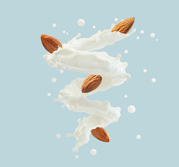 Fresh natural almond milk splash swirl with almonds isolated. Healthy splashing almonds milk or milkshake, almond seeds, yogurt spiral. Organic vegan liquid splash dairy commercial. 3D