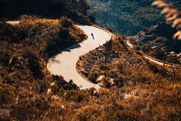 Sticker - Silhouette of biker who ride on road bicycle in mountains