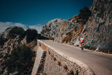 Sticker - Biker on the road bicycle ride uphill on the famous Sa Calobra climb in Spain.