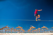 © kovop58 - teenagers balance slackline on summer tropical beach