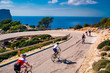 Teamwork sport photo, group of athletes on road bicycle ride by the sea in beautiful nature