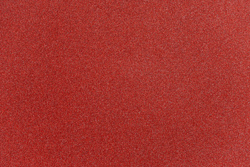 Wall Mural - abstract red glitter paper texture background or backdrop. empty shimmer paper or shiny paperboard f
