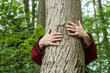 © pixarno - closeup of woman hugging a tree in a forest