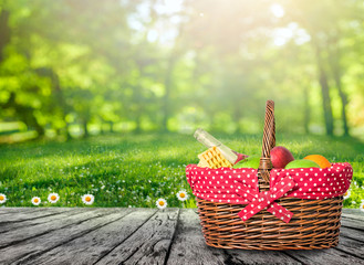 Wall Mural - a wooden picnic table with  picnic basket