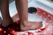 © LIGHTFIELD STUDIOS - cropped view of barefoot bleeding woman in bathroom