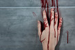 © LIGHTFIELD STUDIOS - bleeding hand and blood print on grey wall
