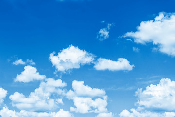 Blurred background. Blue sky and white fluffy clouds.