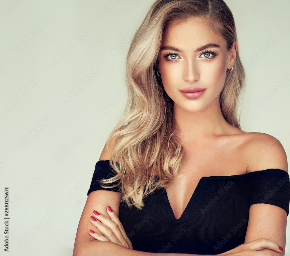 Young, blonde haired woman with   wavy hair .Beautiful model with long,  hairstyle . - obrazy, fototapety, plakaty 