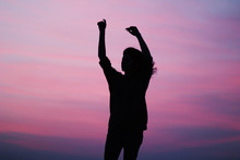 Silhouette Of Woman Raising Her Hands