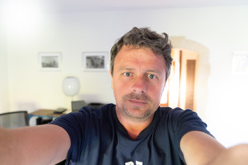 man looking at his cellphone smartphone making selfie
