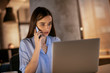 © JustLife - Woman working at the office. Businesswoman talking on the phone.