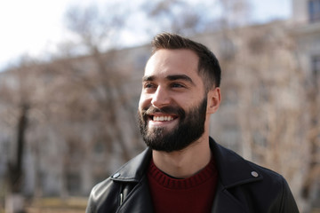 Wall Mural - Portrait of happy young man outdoors on sunny day