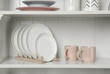 © New Africa - White shelving unit with set of dishware