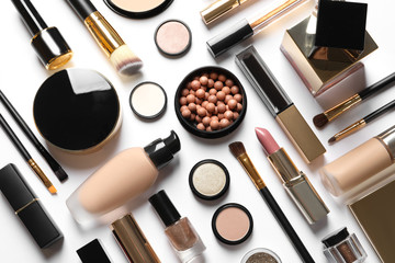 set of luxury makeup products on white background, flat lay