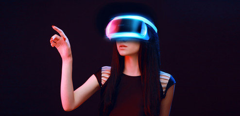 Wall Mural - model young woman in glasses of virtual reality on dark background.. augmented reality, science, fut