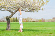 © Dmytro Flisak - Woman is practicing yoga, doing Salamba Sirsasana exercise, standing in headstand pose near tree