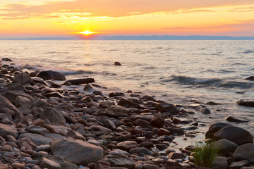 Wall Mural - beautiful natural background. summer sunset at the shore of baikal lake. hikes along the lakeside of