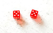 © Lubo Ivanko - Two red craps dices showing Hard Ten (double number five) overhead shot on white board