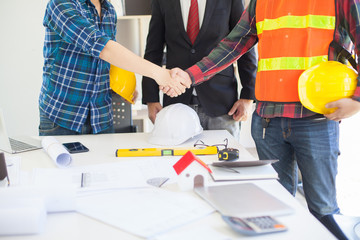 Wall Mural - Concept Agreement between the employer and architect Nick and desk of Architectural project in construction site or office building with mining light