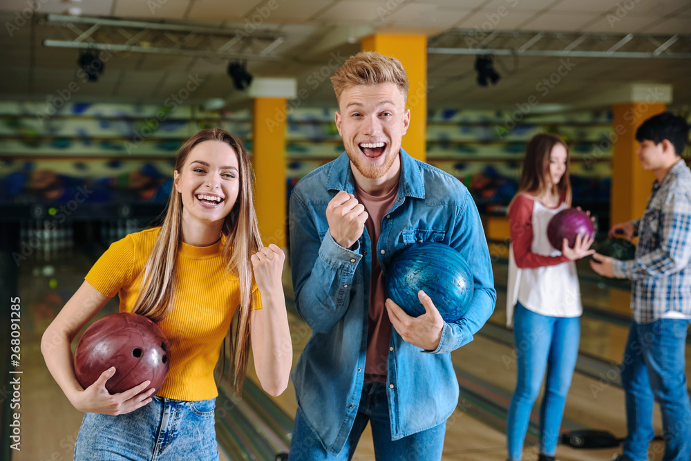 Happy friends in bowling club