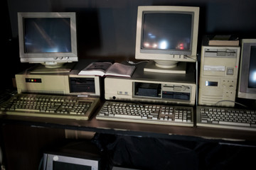 Close-up of ancient old and obsolete personal computer home use on old table wood. Obsolete technology concept.