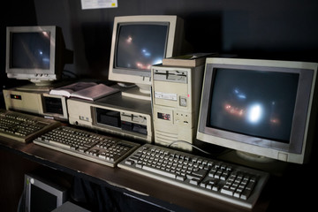 Close-up of ancient old and obsolete personal computer home use on old table wood. Obsolete technology concept.