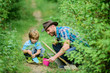© be free - Little helper in garden. Farm family. Little boy and father in nature background. Gardening tools. Gardening hobby. Dad teaching little son care plants. Spring gardening routine. Planting flowers