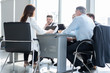 © opolja - Businesspeople discussing together in conference room during meeting at office.