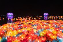 Floating Colored Lanterns And Garlands On River At Night On Vesak Day For Celebrating Buddha's Birthday In Eastern Culture, That Made From Paper And Candle