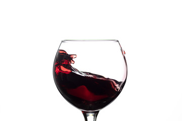 Wall Mural - Red wine splash into glass on white background