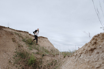 Portrait of a guy running through the mountains in search. Nutrition of confusion, feelings, despair, haste