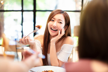 Wall Mural - young woman with friends having dinner in the restaurant