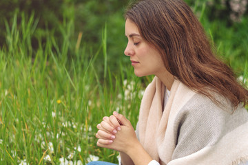 Wall Mural - Christian worship and praise. A young woman is praying in the morning.