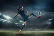 © master1305 - Young female soccer or football player with long hair in sportwear and boots kicking ball for the goal in jump at the stadium. Concept of healthy lifestyle, professional sport, hobby, motion, movement