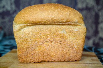 loaf of bread lying on a cutting board