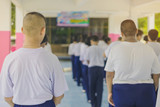Fototapeta  - Group of students try to meditate for the peace of mind by walk with Buddhist monk in school.