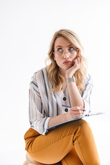 Sticker - Photo of blond thinking woman wearing glasses sitting in chair and looking upward