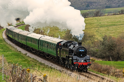 Fotografía Steam locomotive working hard pulling a train