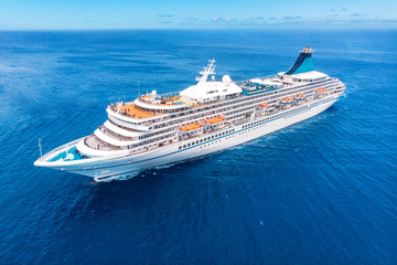 Wall Mural - Cruise liner ship in ocean with blue sky. Aerial top view