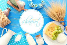 Top View Photo Of Dairy Products Over Blue Wooden Background. Symbols Of Jewish Holiday - Shavuot
