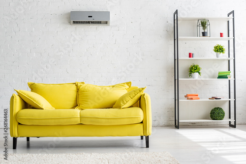 Spacious Living Room With Air Conditioner On White Wall