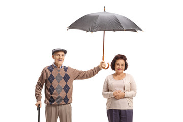 Poster - Elderly gentleman holding an umbrella over an elderly lady