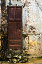 A Decrepit Door On A Very Old Dirty Wall