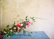 © Ali Harper Photography/Stocksy - Bright gold and pink floral centerpiece
