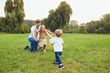 © Studio Romantic - Happy family playing on the grass in the park.