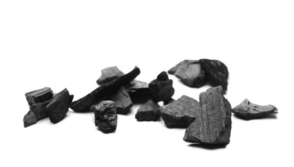 Black charcoal chunks, pile isolated on white background