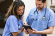 © Sean Locke Photography/Stocksy - Clinic: Technicians Looking At Results On Digital Tablet