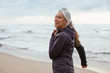 © Bonninstudio/Stocksy - Active senior woman doing sport on the beach.
