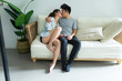 © Bo Bo/Stocksy - Young asian couple sitting in sofa and kiss at home